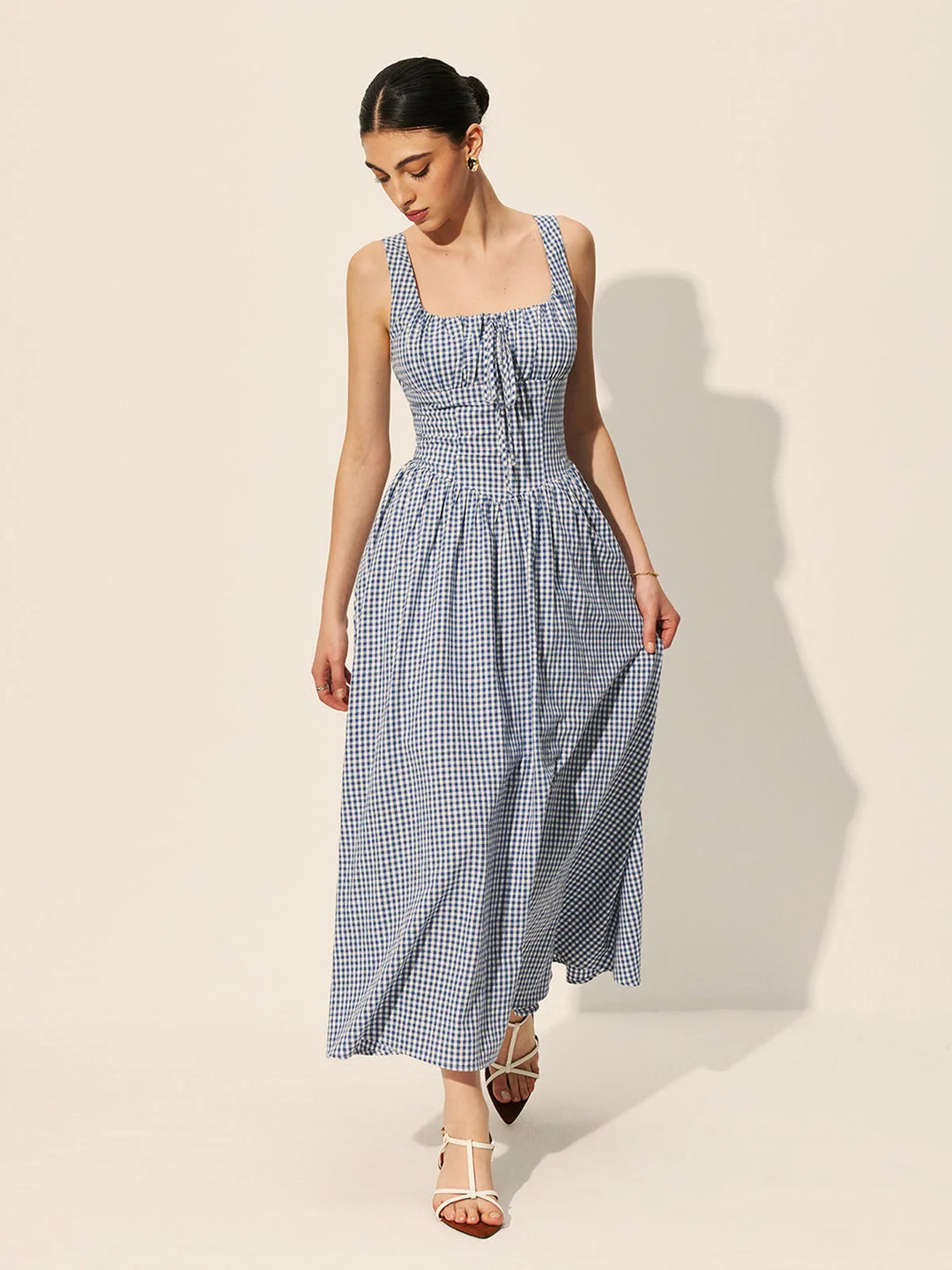 Sleeveless navy gingham cotton maxi dress with a relaxed fit and stylish design for a chic and comfortable look.