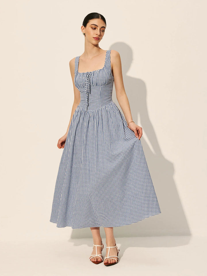 Sleeveless navy gingham cotton maxi dress featuring a classic design with a checkered pattern, ideal for casual and stylish…