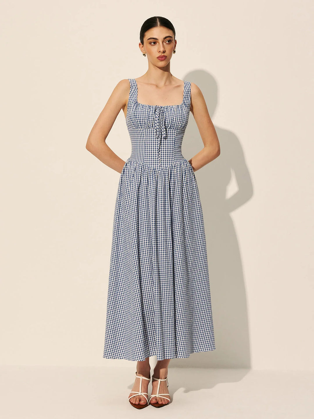 "Sleeveless navy gingham cotton maxi dress in Blue, featuring a classic design perfect for casual occasions. Soft and…