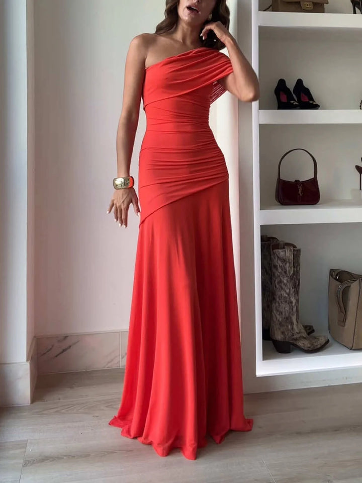 Pink off-shoulder maxi dress with ruched detailing, perfect for elegant occasions.
