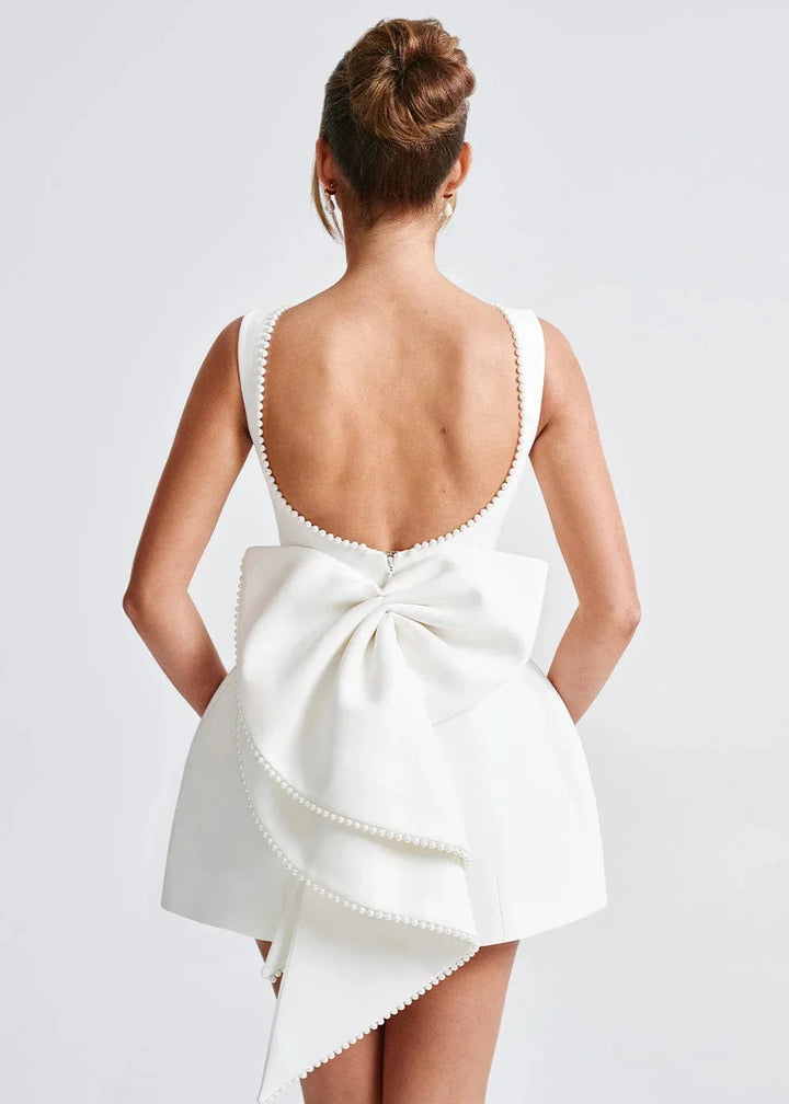 Navy blue backless mini dress with bow detail, made from soft velvet fabric. Perfect for a chic night out or special…