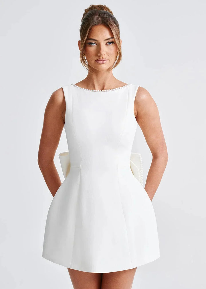 Backless fitted mini dress with bow in olive green stretchy fabric, perfect for a stylish and chic evening look.