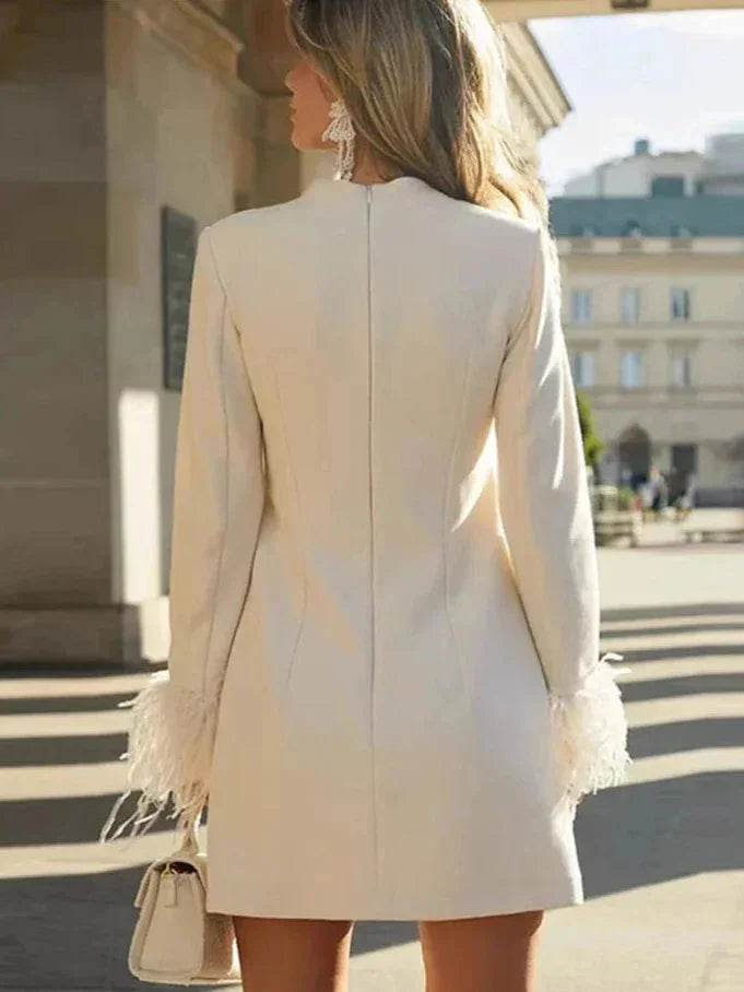White mini dress with feather cuffs, perfect for a chic and elegant look. Made from soft and lightweight material, ideal for…