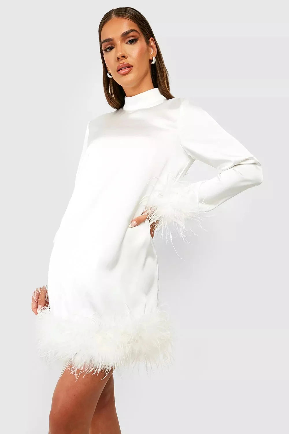 White mini dress with feather cuffs, made of soft cotton blend. Features a trendy design perfect for a chic and stylish look.