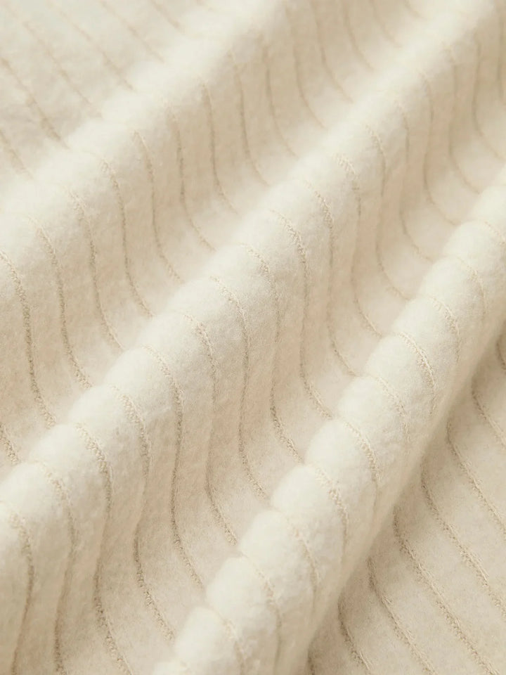 "Beige ribbed pullover with a V-neck and long sleeves made from a soft and cozy fabric blend, perfect for casual and…