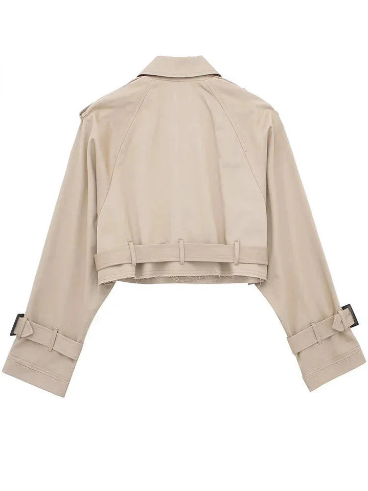 Manuela cropped trenchcoat in classic beige, with chic buckle details and elegant waist tie, perfect for effortlessly…