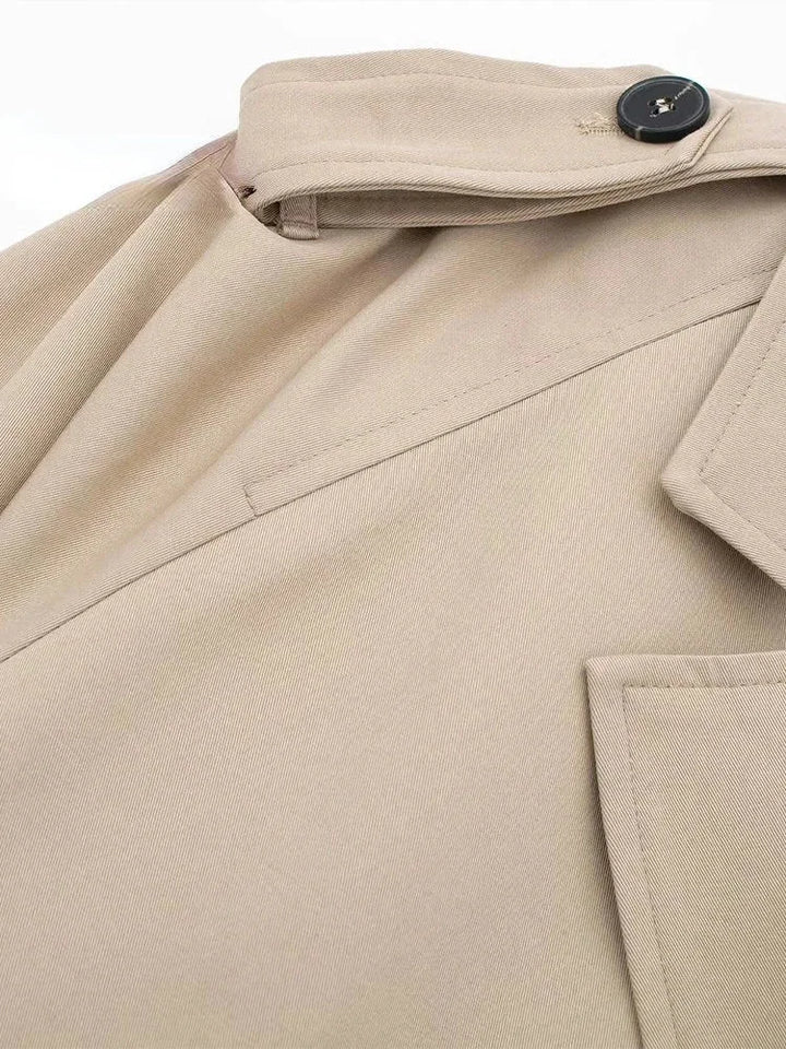 Stylish cropped trenchcoat in beige with chic buckle detailing, perfect for a fashionable and modern look.