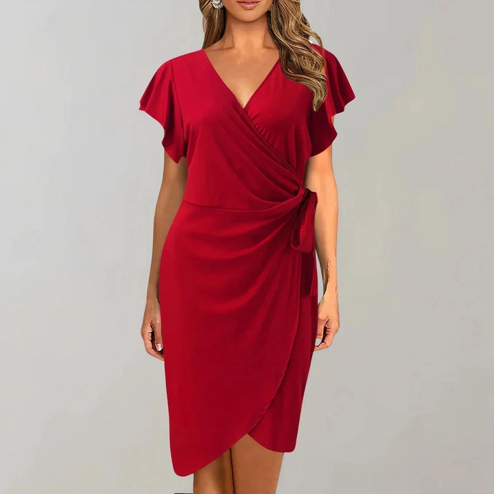 Black V-neck wrap-style dress with flutter sleeves. Made of soft jersey fabric for a flattering silhouette. Perfect for any…