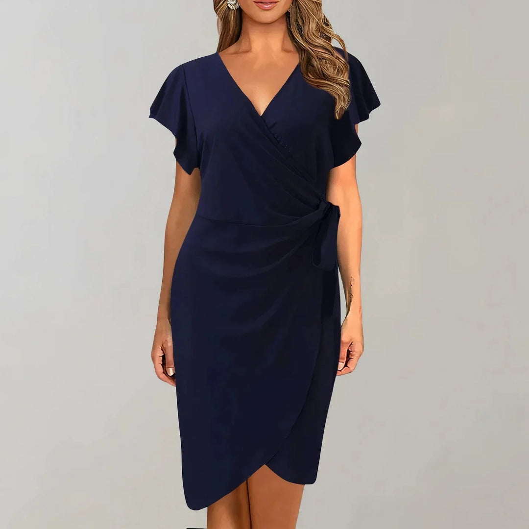 "Navy blue wrap-style flutter sleeve dress made from soft and flowy fabric, perfect for a chic and effortlessly elegant…