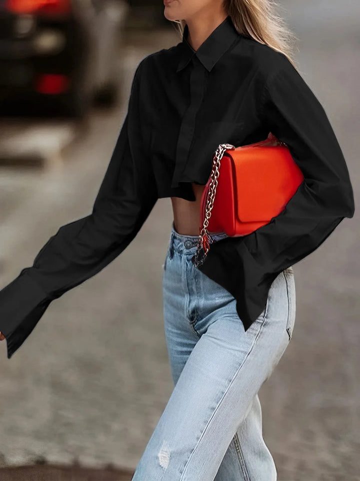 "Black cropped button-up blouse with a modern design and collar, made of soft and breathable cotton blend fabric"