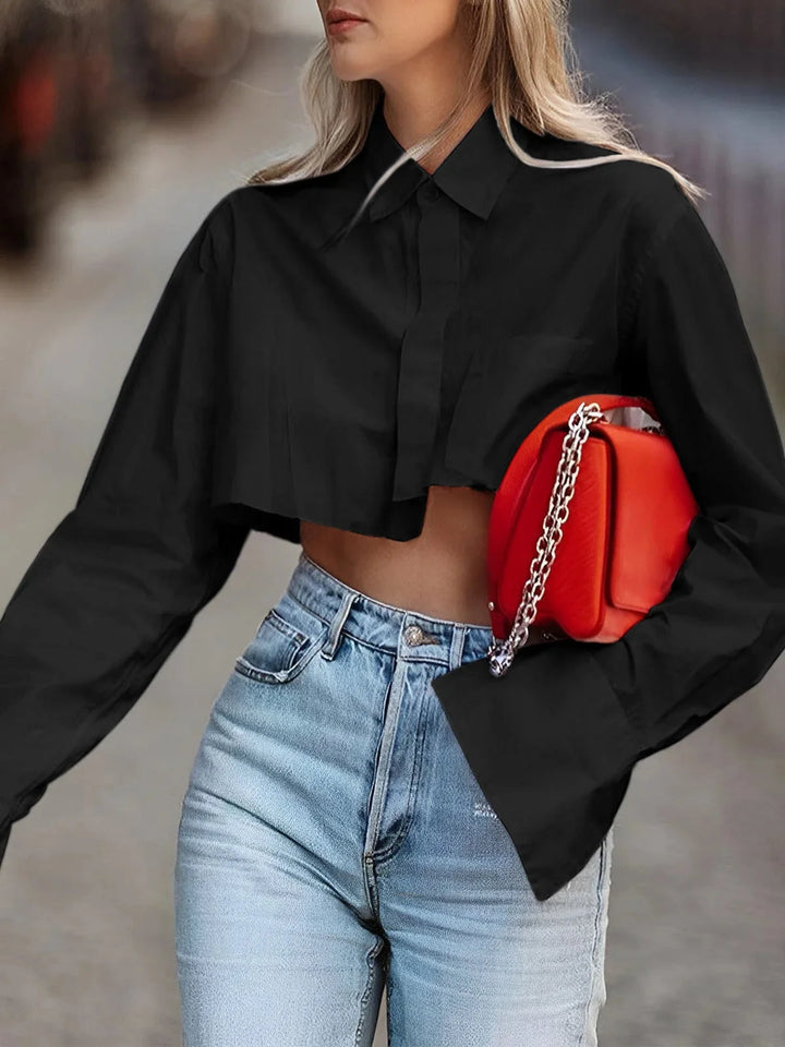 "Black cropped button-up top with modern design and sleek finish."