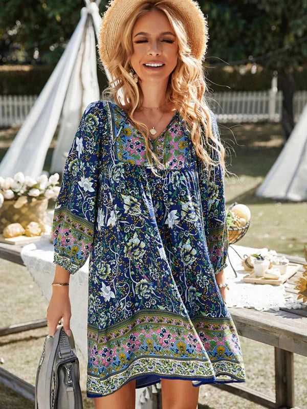 Navy mini dress with boho-inspired delicate prints. Features a flowy silhouette and intricate designs.