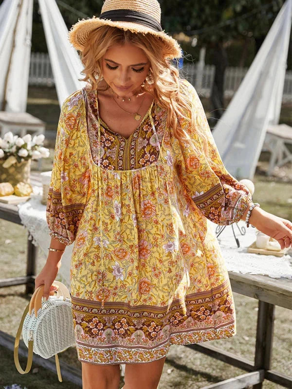 Yellow boho mini dress with intricate prints, perfect for summer. Made with lightweight, airy material for a comfortable fit.