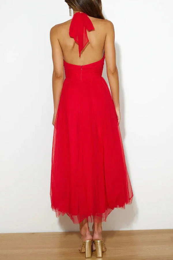 "Marisela halter neck pleated midi dress in soft chiffon fabric with a delicate floral print pattern."