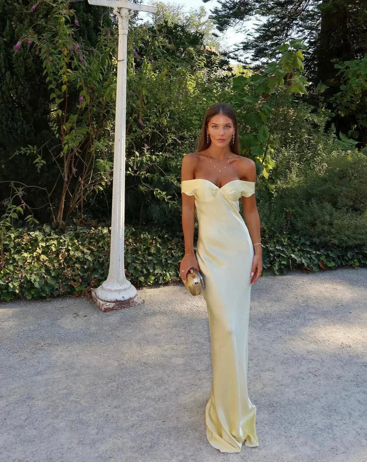 Cream off-shoulder maxi dress from Marvel, paired with matching clutch. Features a flowy silhouette in a soft, comfortable…