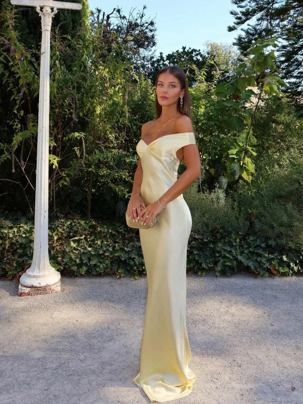 Yellow off-shoulder maxi dress with matching clutch, made from cream-colored material. Perfect for a stylish and elegant…