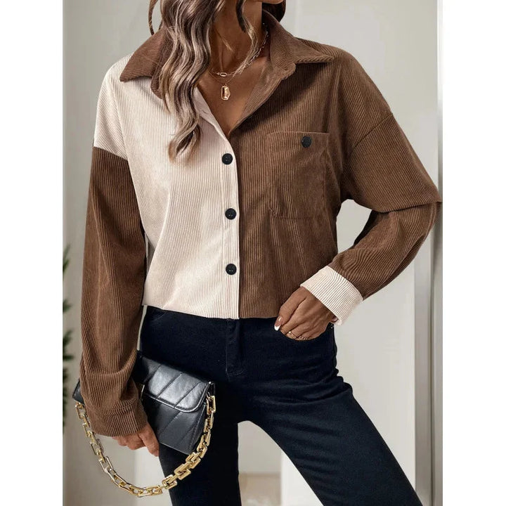 "Matilda blouse in two-tone design with button-up front and pockets, made of lightweight cotton blend fabric."