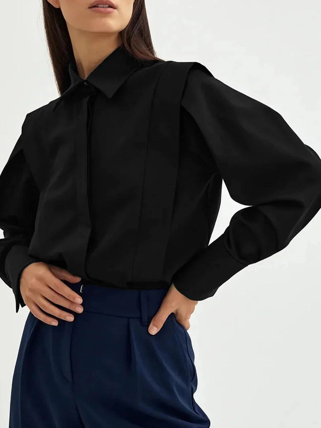 Black oversized shirt with button details, casual yet stylish. Made of soft cotton blend, perfect for a relaxed look.