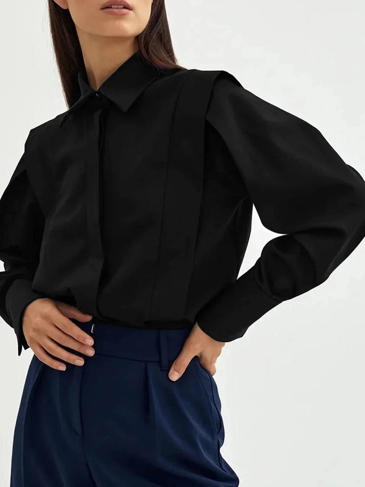 Black oversized shirt with button details, casual yet stylish. Made of soft cotton blend, perfect for a relaxed look.