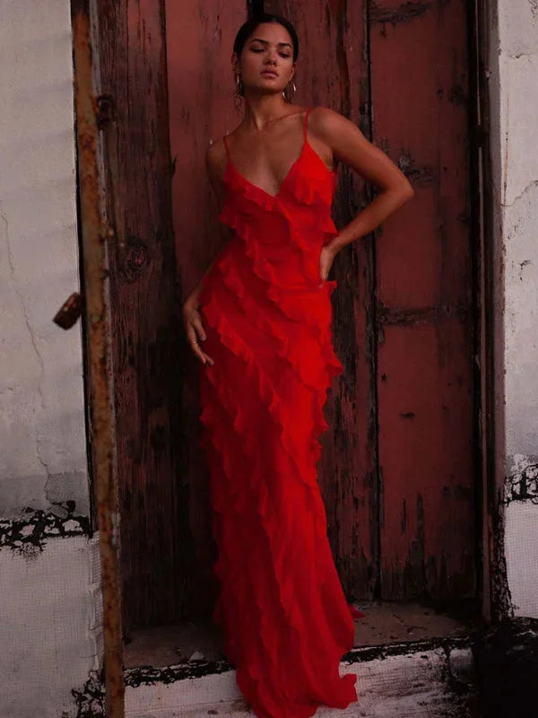 Red tiered ruffle maxi dress with spaghetti straps, made from flowy fabric. Perfect for a chic and stylish summer look.