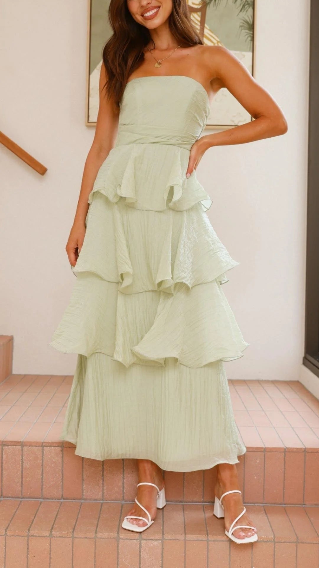 "Strapless tiered dress in flowing chiffon fabric with elegant layers, ideal for special occasions."