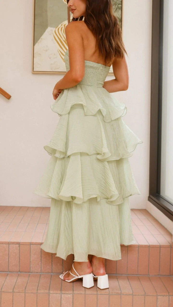"Strapless tiered dress made with flowy fabric and elegant layered design in a soft blush color."