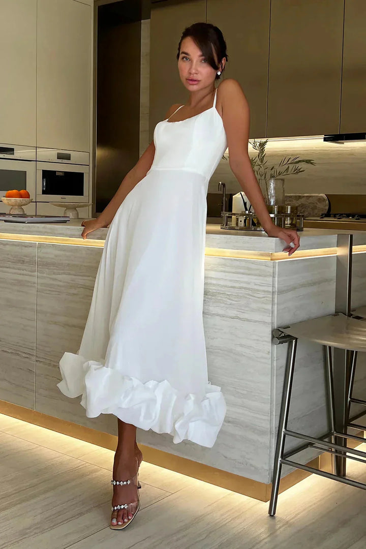 White midi dress with ruffle detail. Made from lightweight cotton blend with a soft silhouette. Perfect for a casual summer…