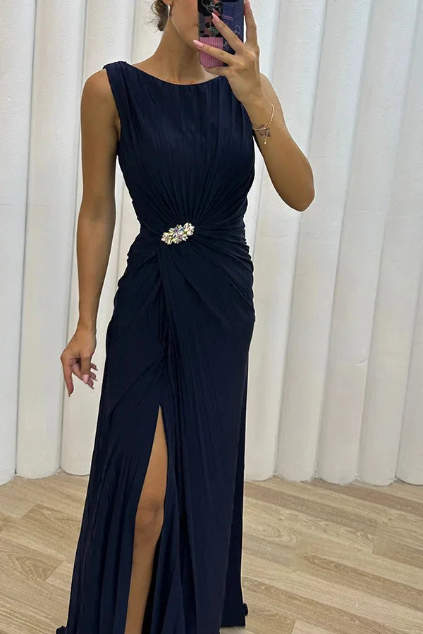 Navy blue maxi dress with pleats and jewel detailing, suitable for formal events and gatherings.