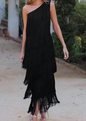 Black one-shoulder midi dress with fringe detailing, made of soft and stretchy fabric for comfort and style.
