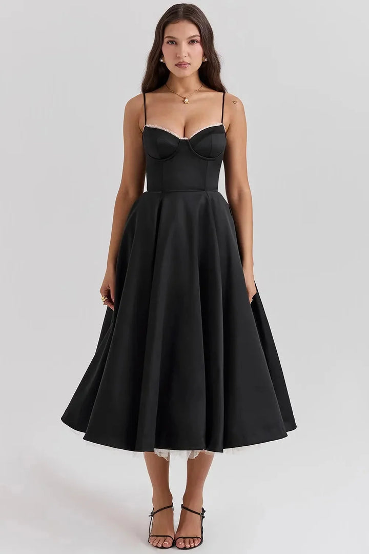 "Black satin dress with cream tulle overlay, perfect for a sleek and elegant look."