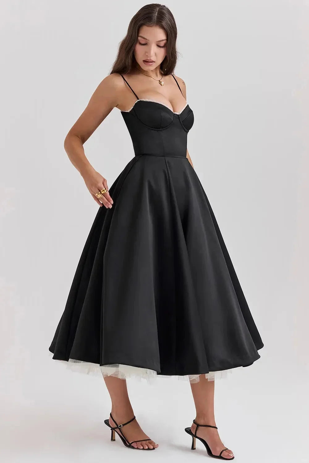 "Satin black dress with soft cream tulle detailing, elegant and chic for special occasions."