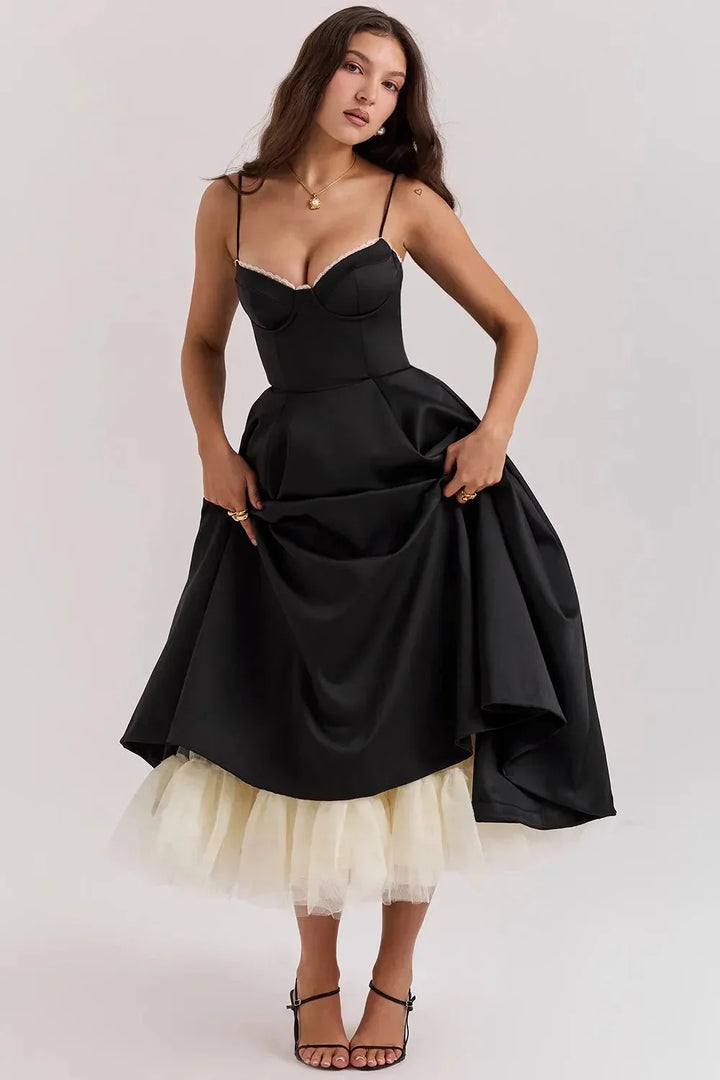 "Elegant satin black dress with delicate cream tulle, perfect for a sophisticated look."