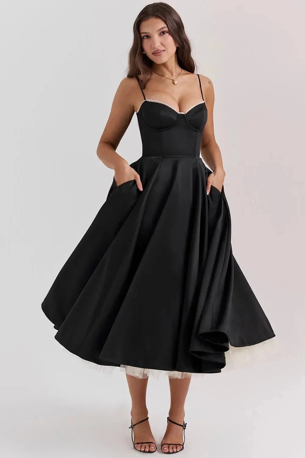 Satin black dress with soft cream tulle overlay, perfect for special occasions or formal events.