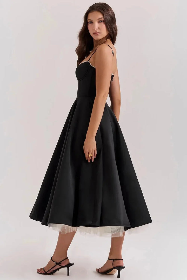 "Satin black dress with delicate cream tulle detailing, perfect for elegant occasions."