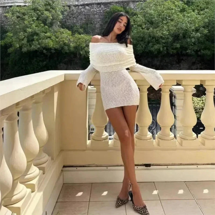 Off-shoulder mini dress with sparkles, perfect for sunny events. Features a flattering design in a lightweight and…