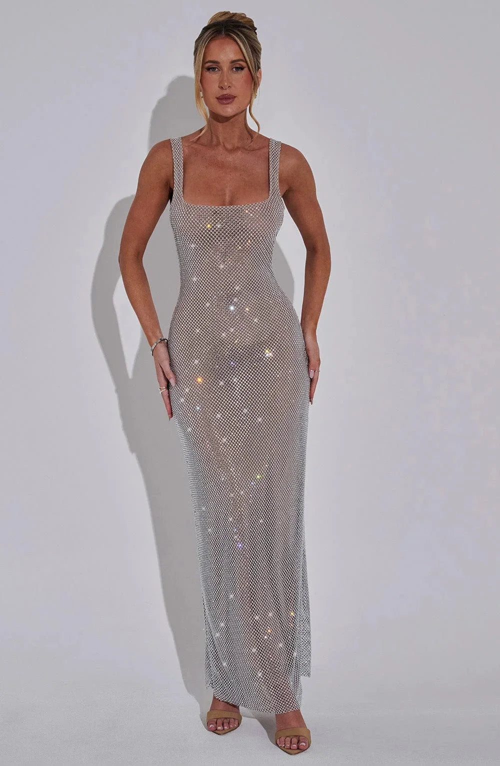 Silver sleek mesh maxi dress for women, featuring a modern design with a flowy silhouette and delicate mesh fabric.