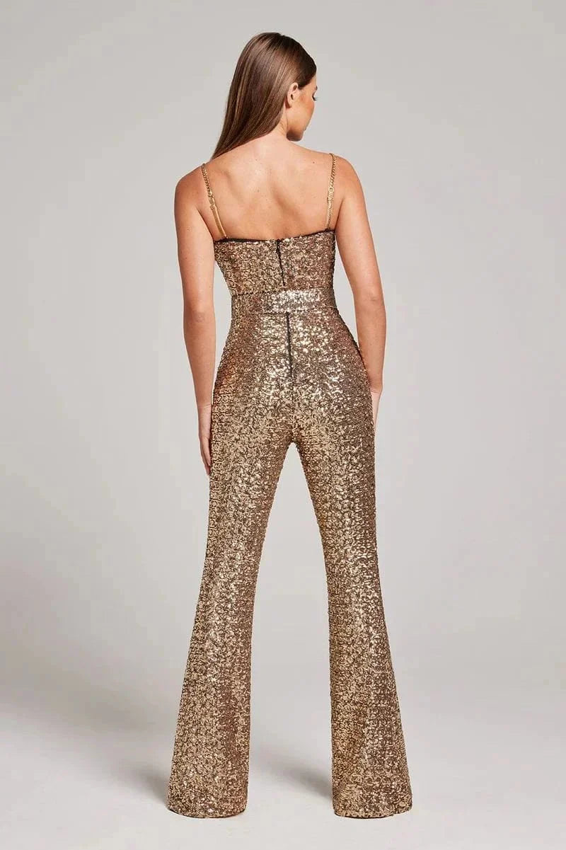Shimmering black jumpsuit with strapless design, glitter details, and waist belt by Metztli.
