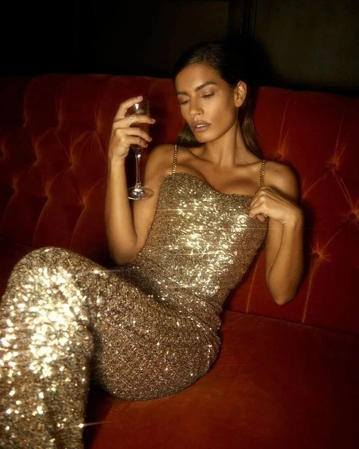 Striking strapless glitter jumpsuit in black with a waist belt for a glamorous look, perfect for evening events and special…