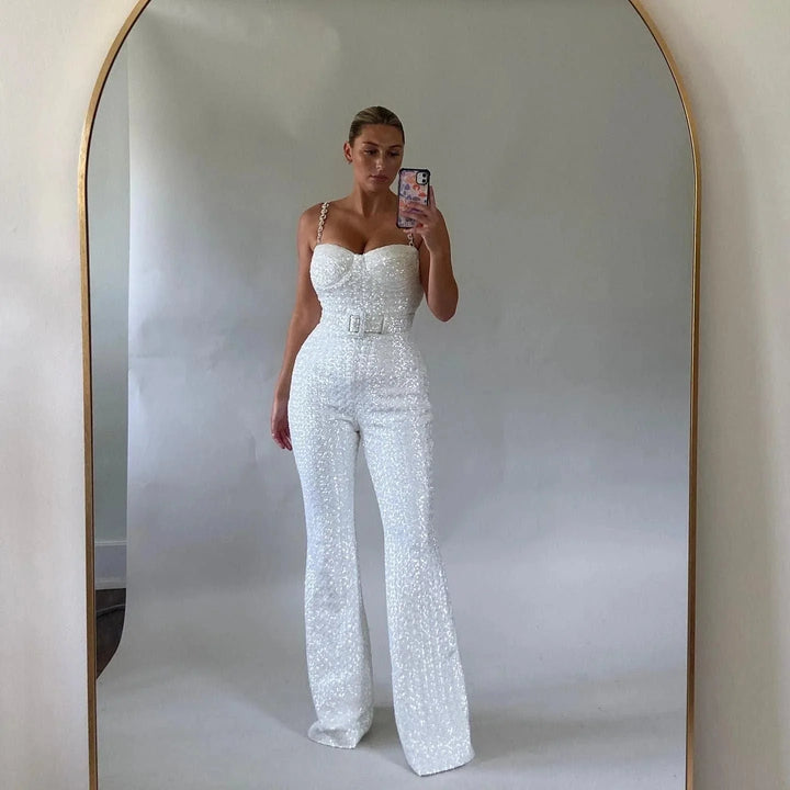 White strapless jumpsuit with shimmering glitter fabric and waist belt detail by Metztli.