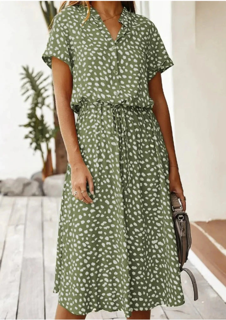 Miani midi dress featuring polka dot pattern, waist tie, and knee-length cut in a comfortable fabric.