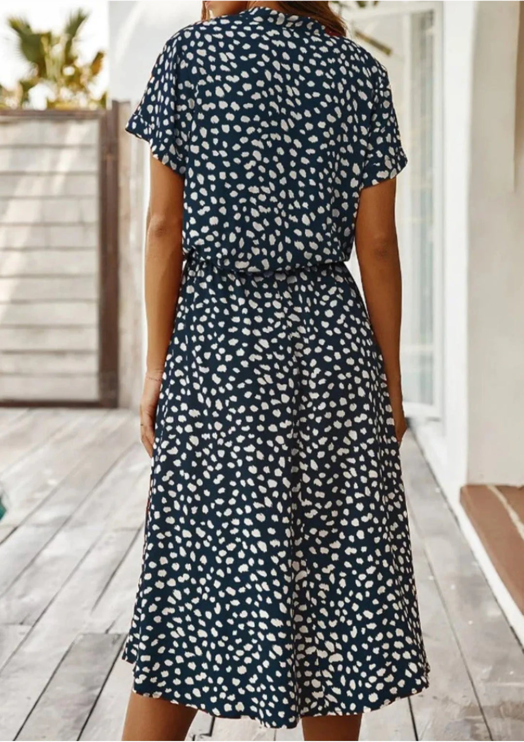 Polka dot midi dress with waist tie in a breathable cotton blend fabric, perfect for a casual yet stylish look.
