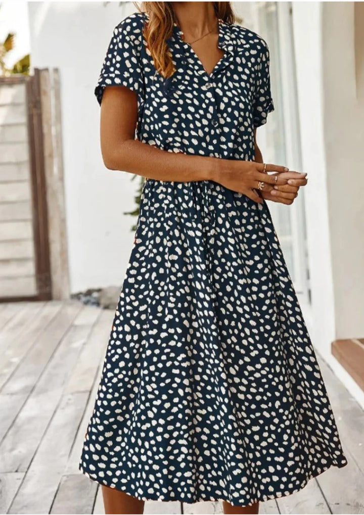 "Navy blue polka dot midi dress with waist tie, perfect for a chic and stylish look. Made from a comfortable and breathable…
