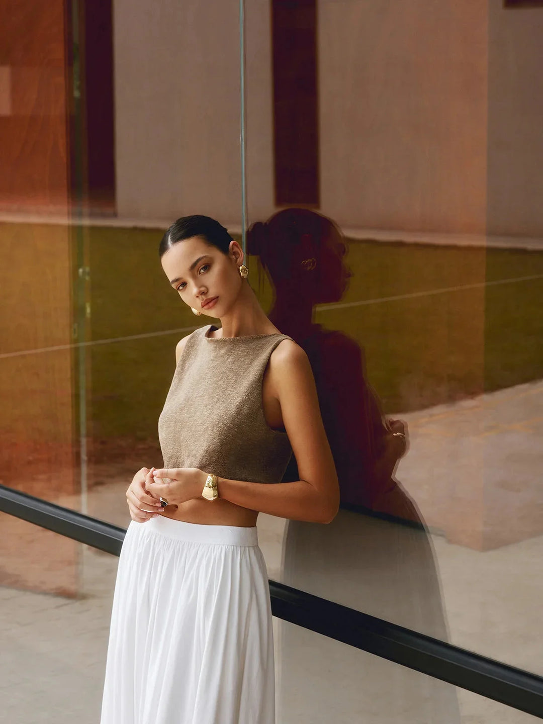 Sleeveless crop top with textured fabric in a sleek, modern design by Mikah.