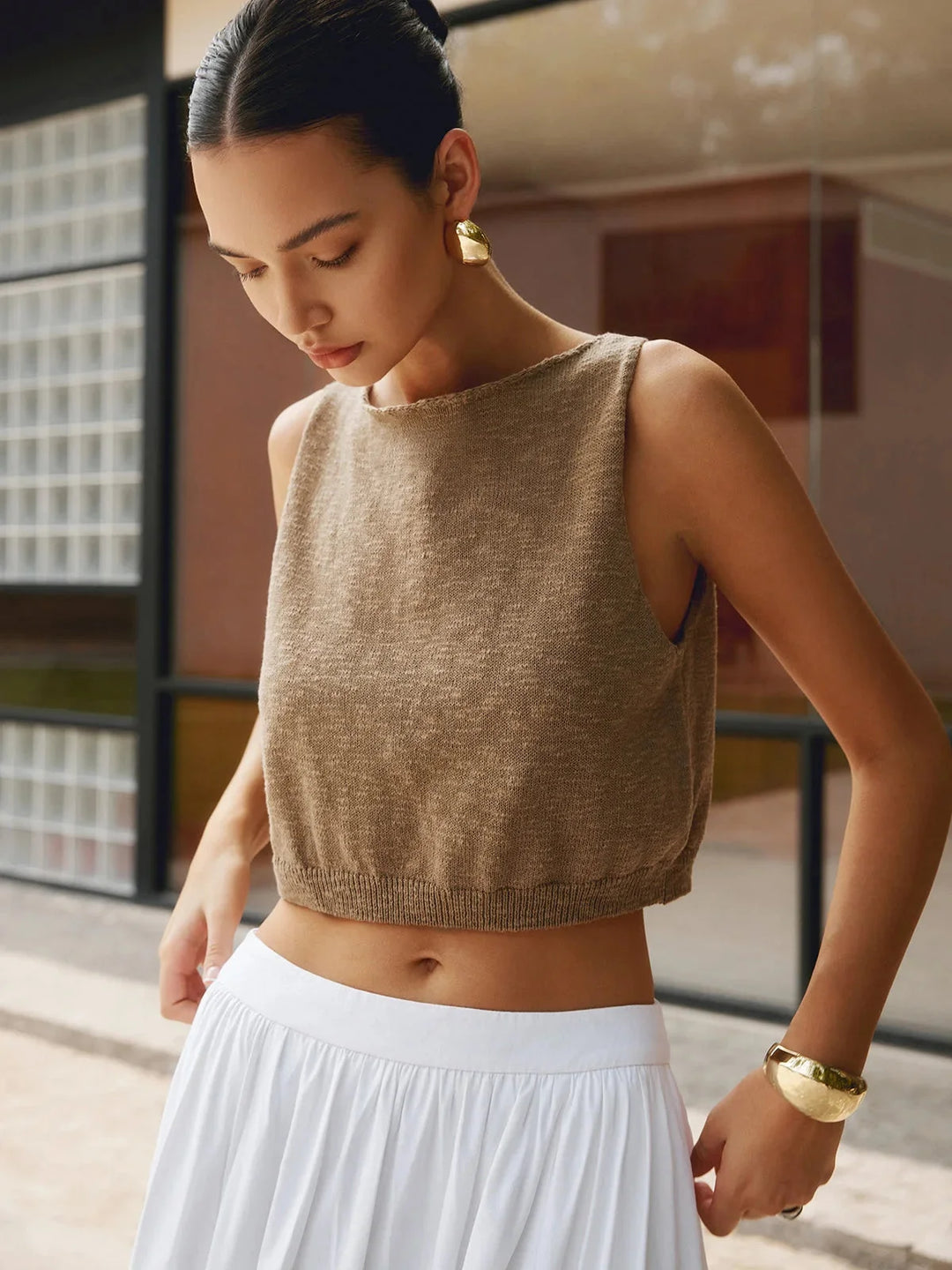 White textured sleeveless crop top with square neckline and ribbed design. Made from breathable cotton blend fabric.