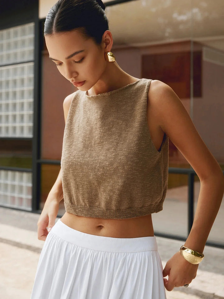 White textured sleeveless crop top with square neckline and ribbed design. Made from breathable cotton blend fabric.