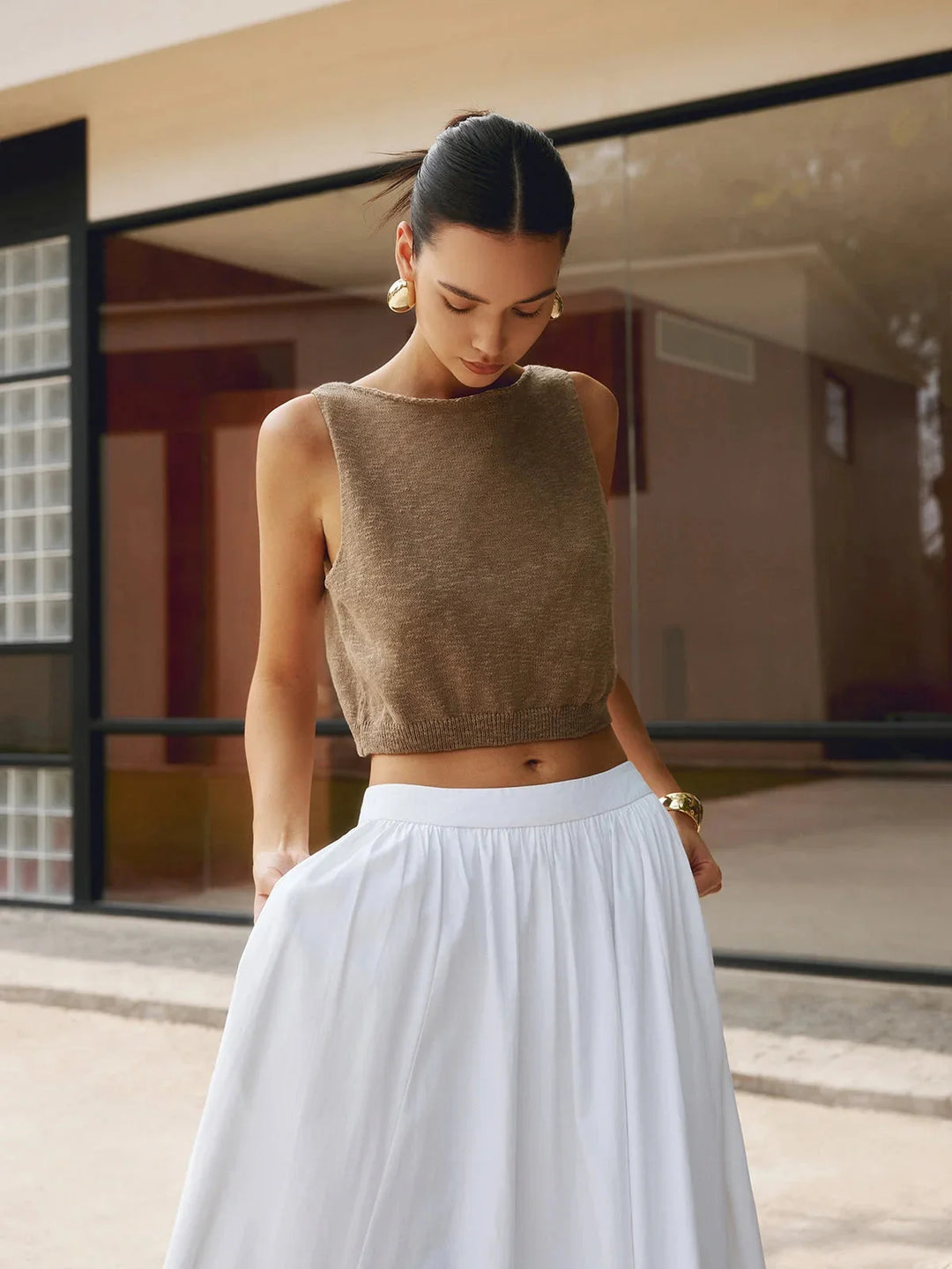 Dark brown sleeveless crop top with textured fabric for a stylish look.