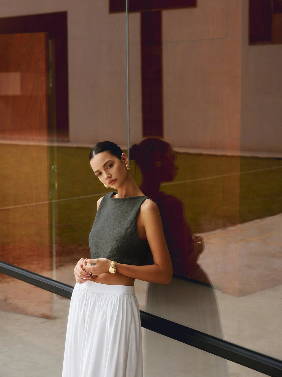 Grey textured sleeveless crop top with a unique design, perfect for casual outfits.