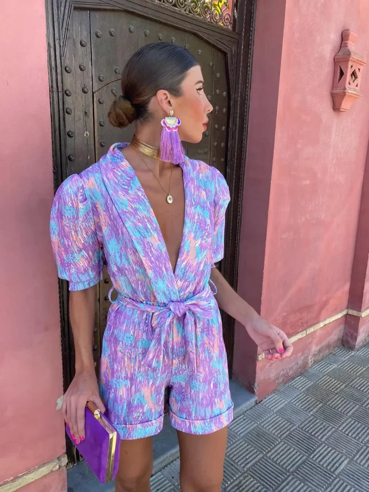 Lilac playsuit in lightweight fabric with tie waist, providing comfort and style for a laid-back look.