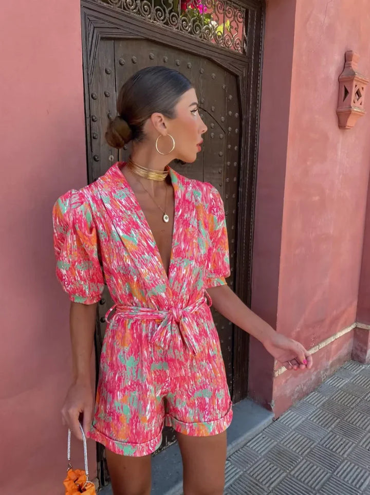 Pink playsuit with tie waist, made of lightweight, comfortable material. Perfect for casual outings or everyday wear.
