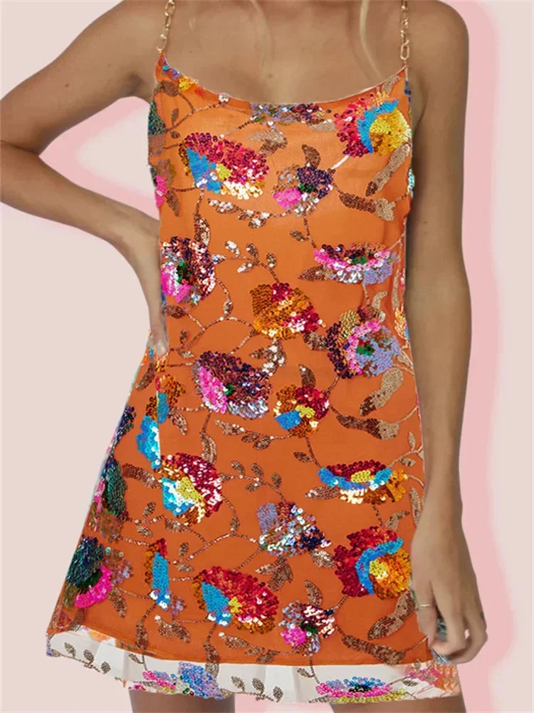 Orange mini dress with vibrant print by Mirella, made with stretchy fabric. Features a sleek design suitable for casual…